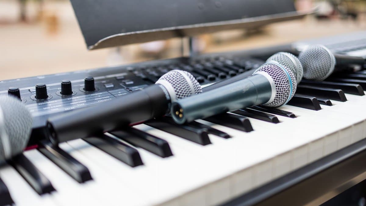 Close-up of microphones on an electronic keyboard, perfect for band practice or live performances.