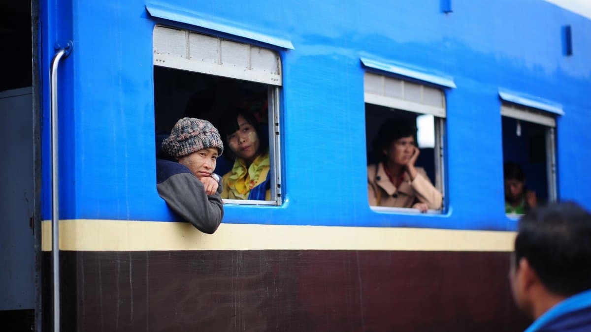 Image of people looking out from a moving train in a moment of reflection.