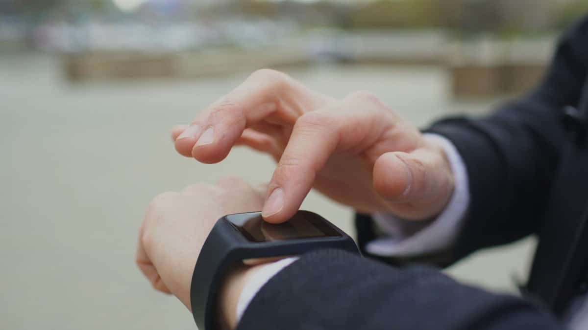 Close-up of a person using a smartwatch, focusing on technology and connectivity.