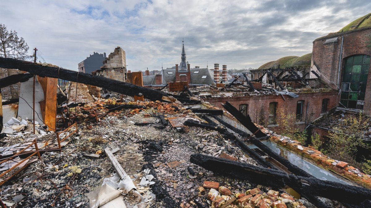 A panoramic view of an abandoned and decayed urban landscape showing broken buildings and debris.