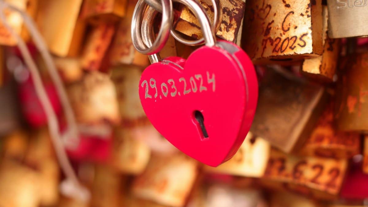 Red heart lock with engraved date among love locks in Holambra, Brazil.