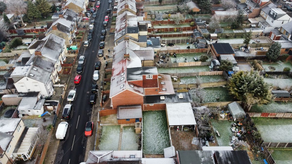 Aerial image of a frost-covered urban residential area with aligned houses.