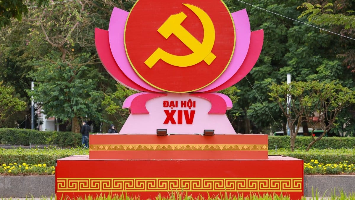 Red and yellow Communist symbol displayed in a Hanoi park setting.