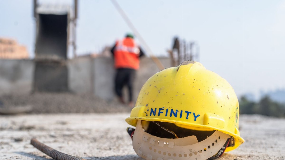 Close-up of a yellow safety helmet on a construction site in Delhi.