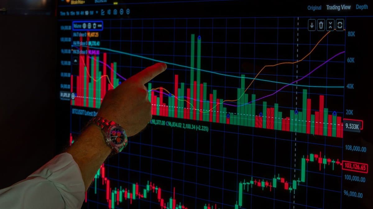 Close-up of a person analyzing Bitcoin market trends on a digital trading platform screen.