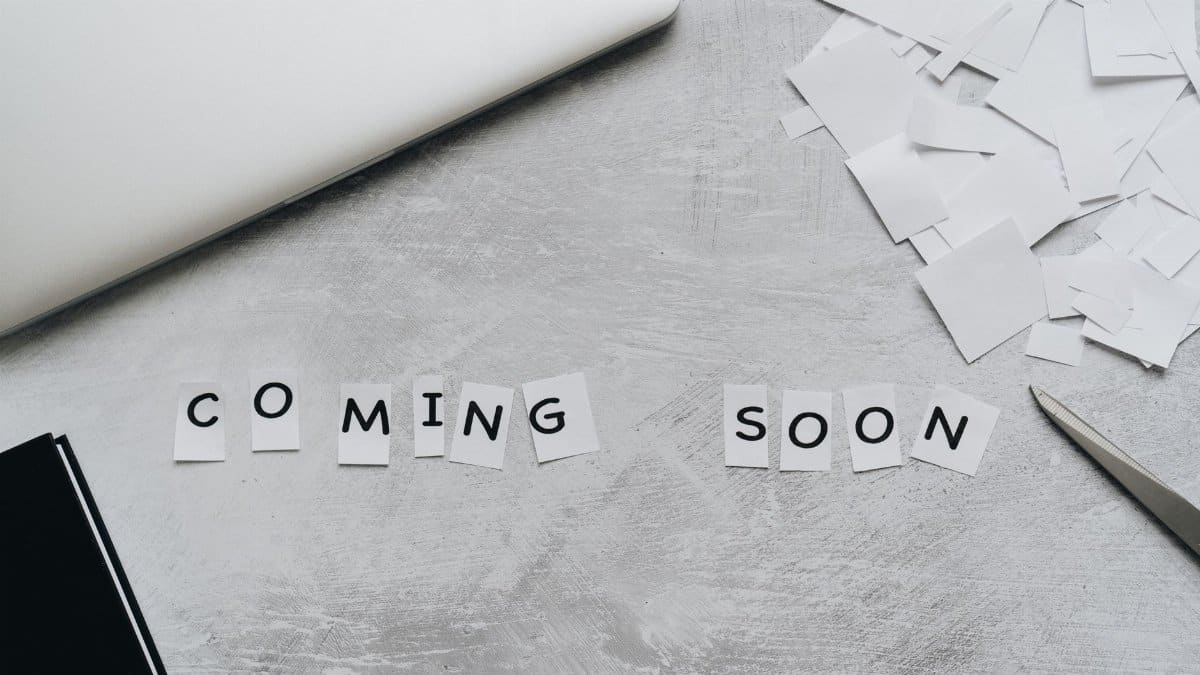 A creative arrangement with paper cutouts spelling 'Coming Soon' on a textured surface.