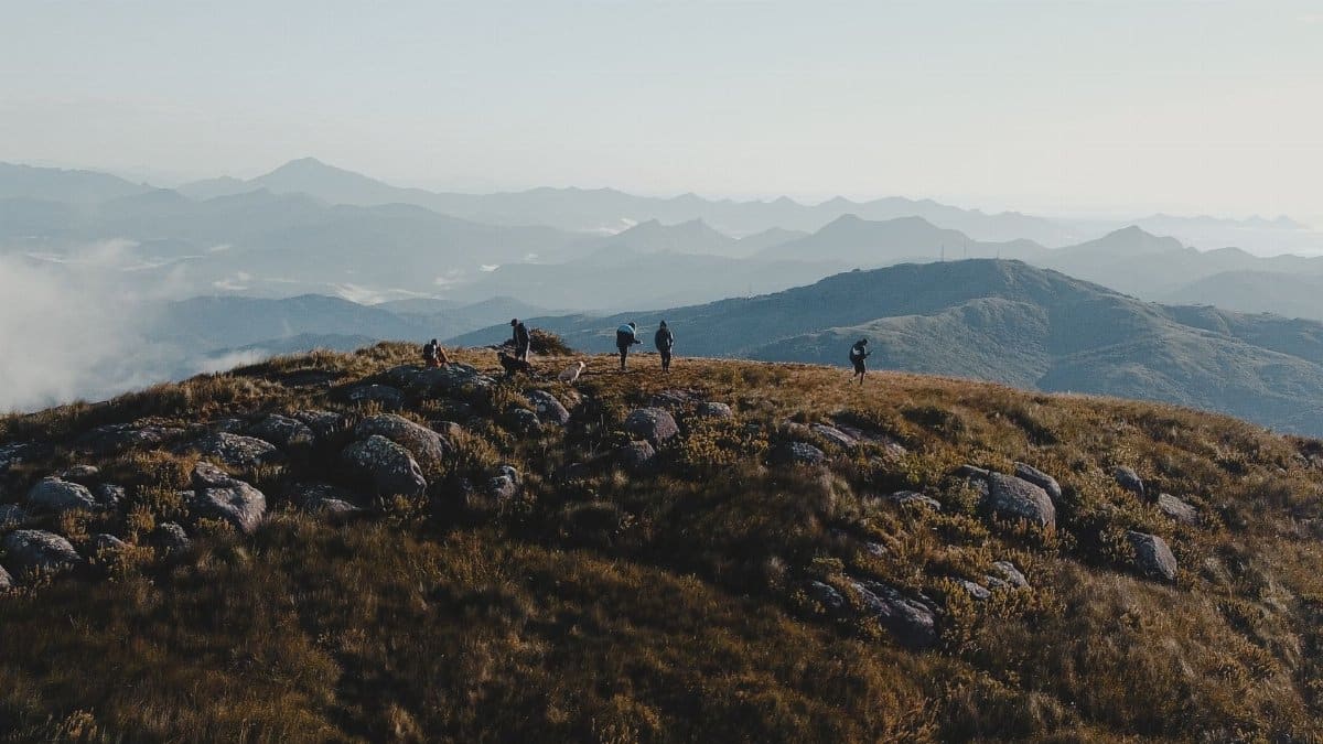 Group of hikers enjoying a scenic mountain view in Tijucas do Sul, Brazil.