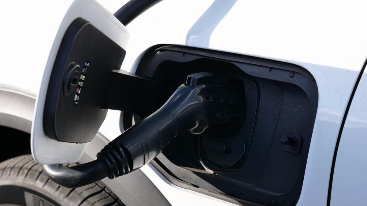 Close-up view of an electric vehicle charging with a focus on the connector and charging port.