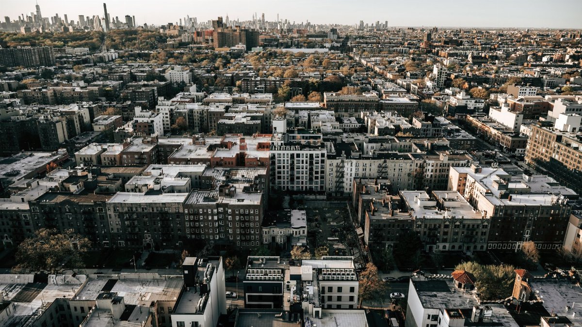 A breathtaking aerial view of Brooklyn with New York City skyline, shot during the day.