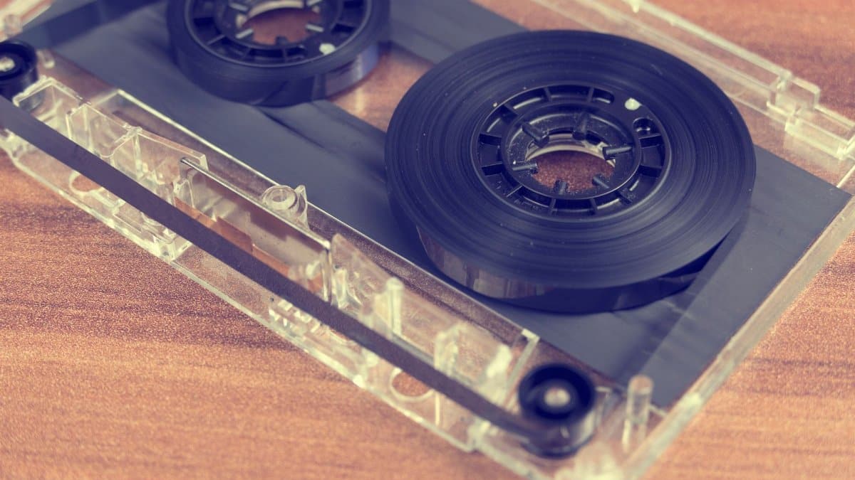 Detailed close-up of a retro audio cassette tape on a wooden surface.