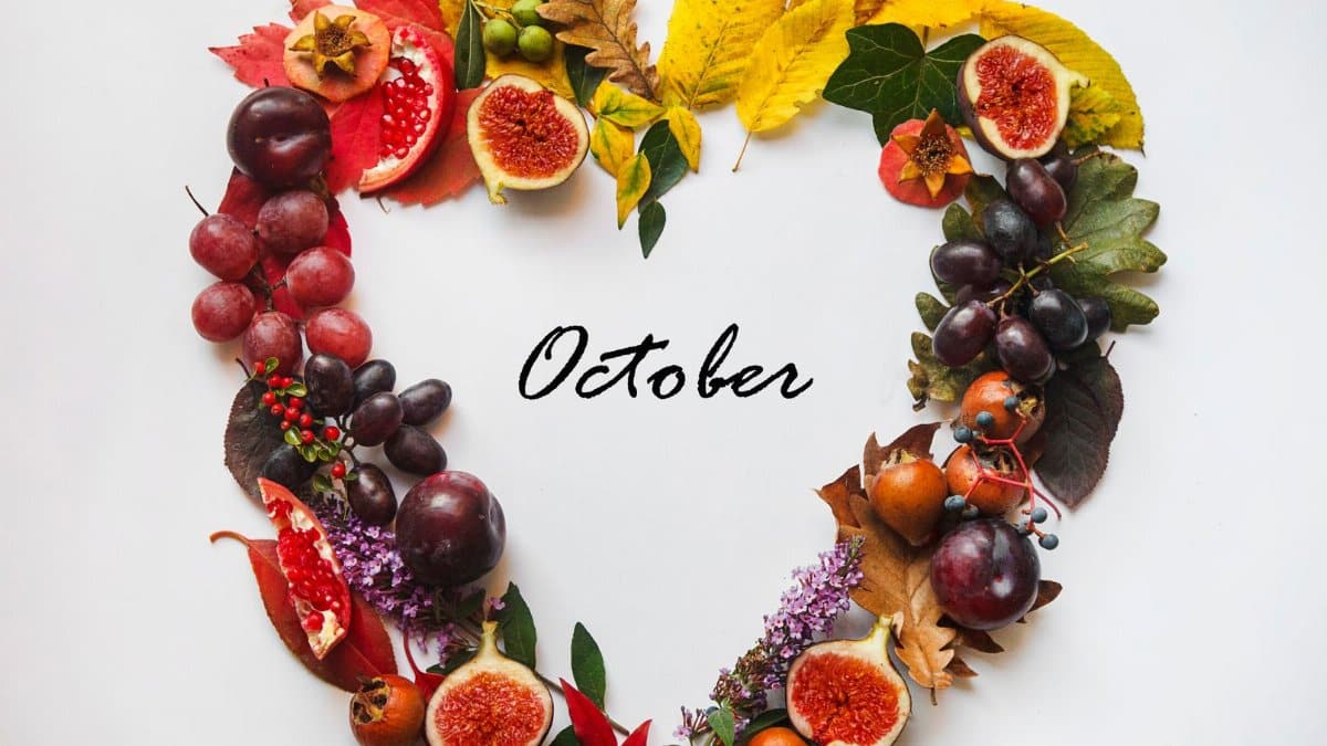 Autumnal heart-shaped wreath made of fruit and leaves, symbolizing October's beauty.