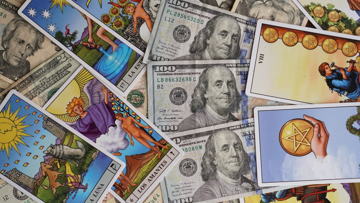 A mix of vibrant tarot cards and US dollar bills creates an intriguing financial concept.