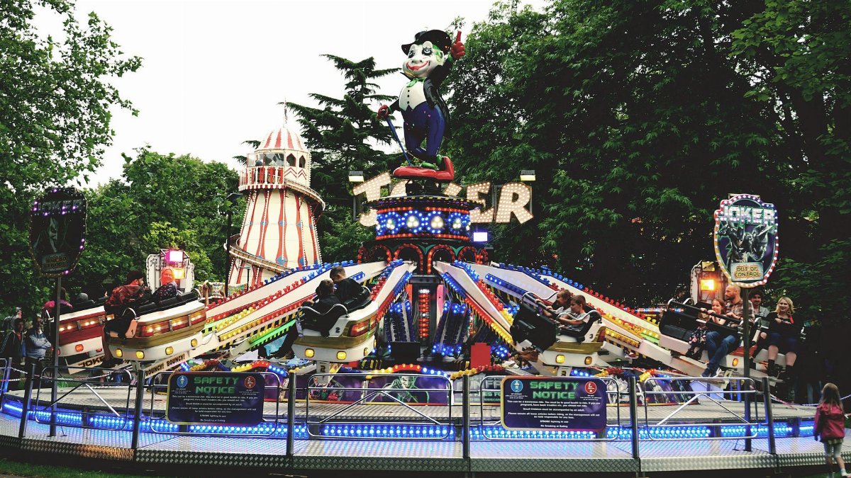 Colorful amusement park ride with people enjoying the fairground atmosphere.