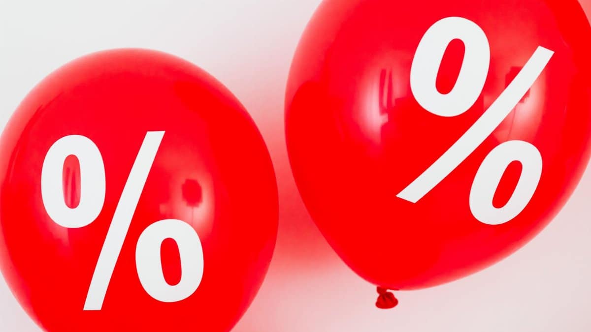Red balloons featuring percentage symbols, ideal for sales and promotions.