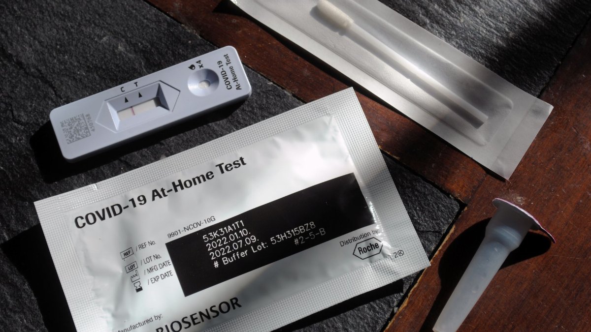 Close-up of a COVID-19 at-home test kit with packaging and test components displayed.