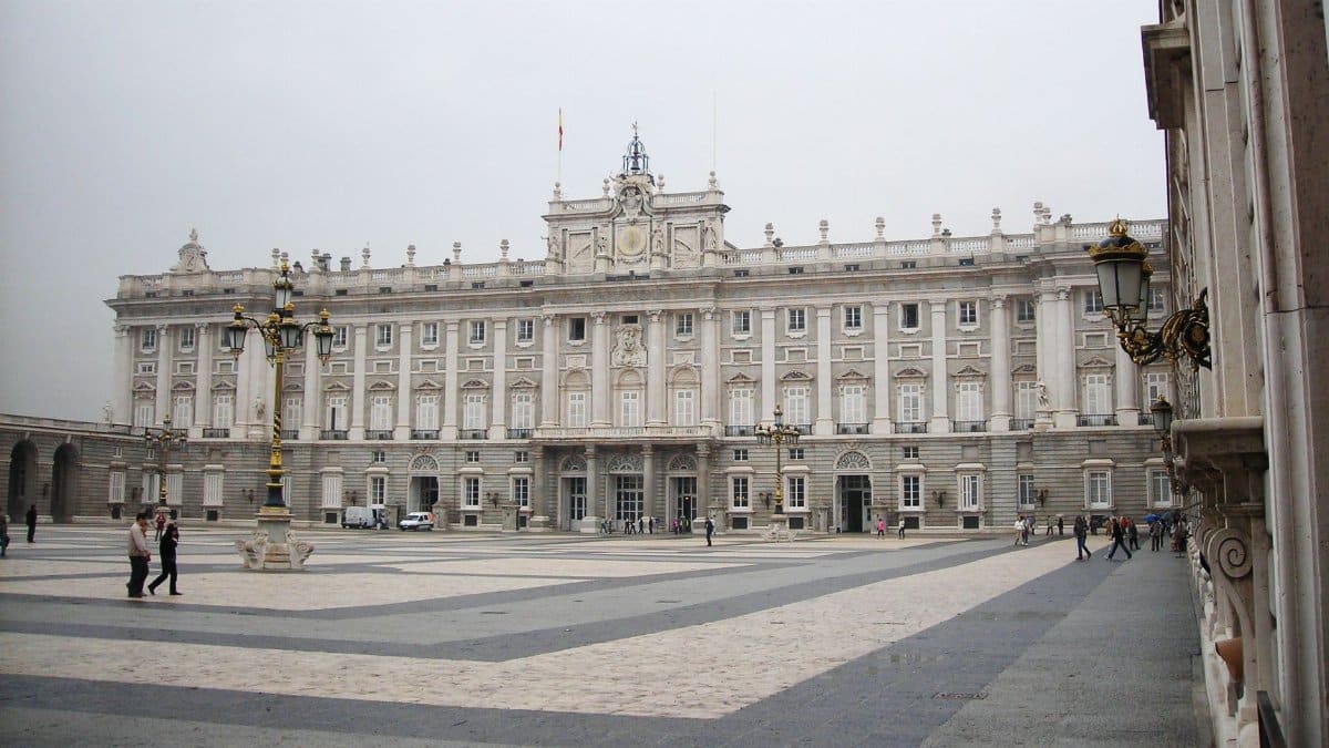 Majestic view of the Royal Palace facade in Madrid's historical plaza.