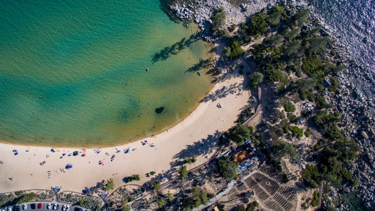 A stunning aerial view of Sand Harbor Beach at Lake Tahoe, showcasing its beautiful sandy shore and clear turquoise waters.