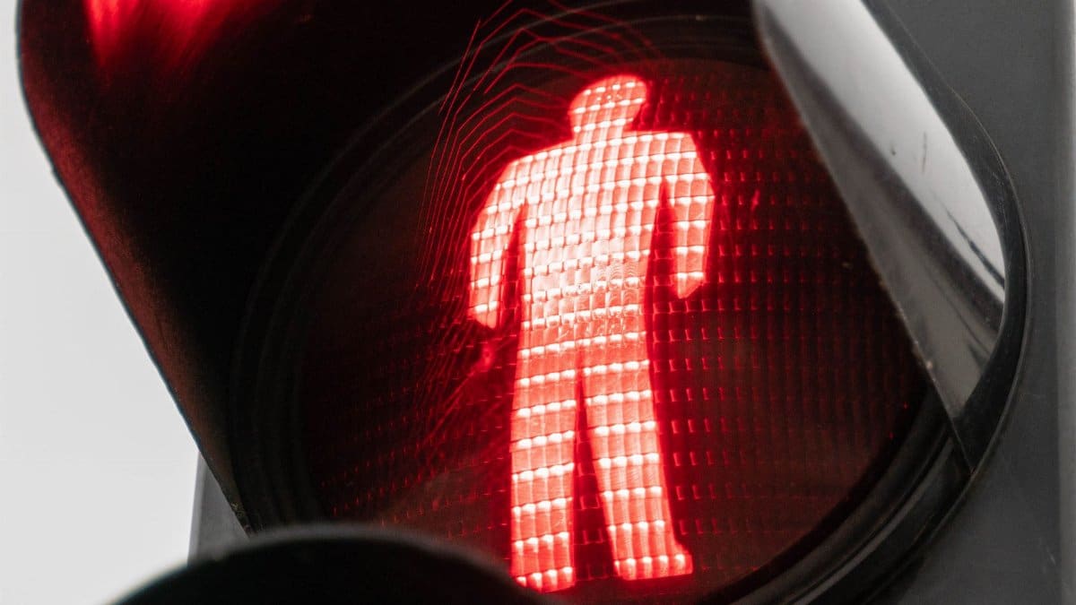 Detailed view of a red pedestrian crossing signal indicating stop.