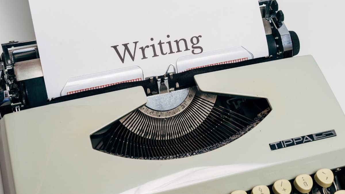 Classic vintage typewriter displaying the word 'Writing' on a sheet of paper.