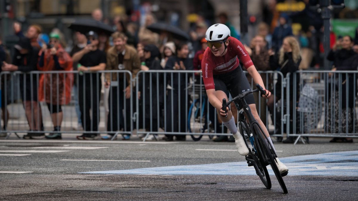 Cyclist speeding through central Copenhagen during a competitive race event.