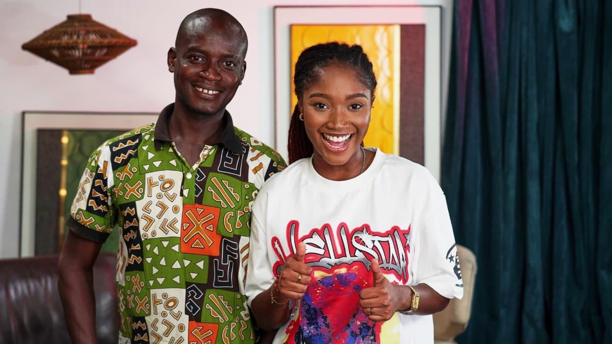 Smiling man and woman posing together indoors in vibrant shirts.
