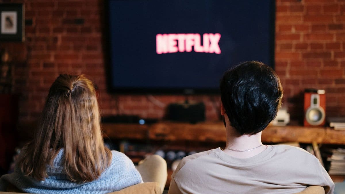 A couple enjoys a relaxed evening watching Netflix in their living room.
