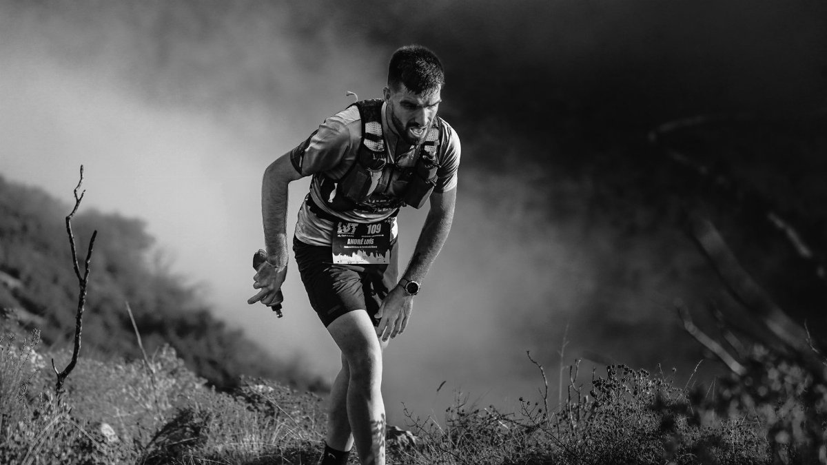 Focused athlete navigating rugged terrain during a competitive trail run.