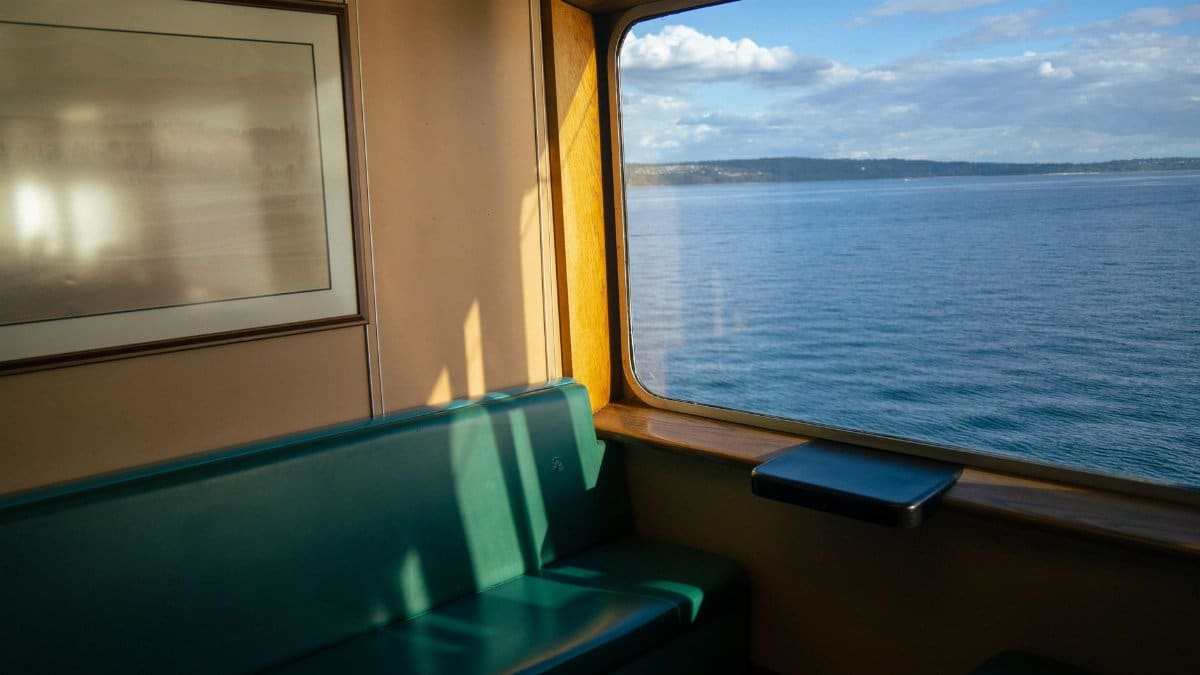 Peaceful ferry interior with scenic Puget Sound view through window, capturing Kingston, Washington.