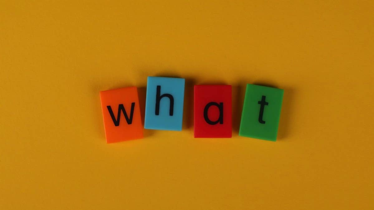Colorful blocks spelling 'What' on a bright yellow background, creating a playful and bold composition.