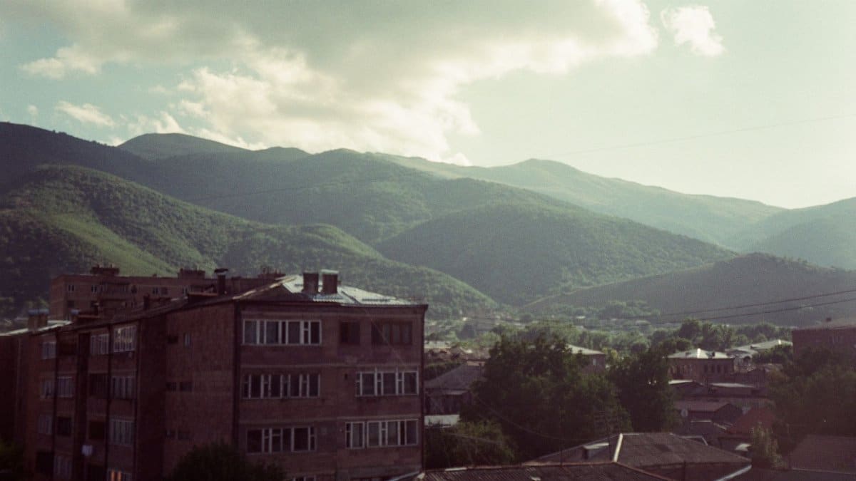 A serene view of Vanadzor cityscape with lush mountains in the background, Armenia.