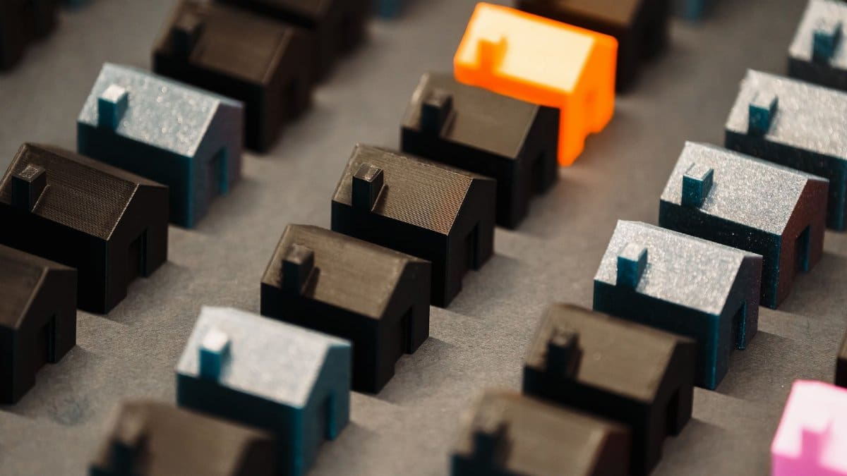 Close-up of colorful 3D model houses showcasing real estate concepts with a vibrant standout piece.