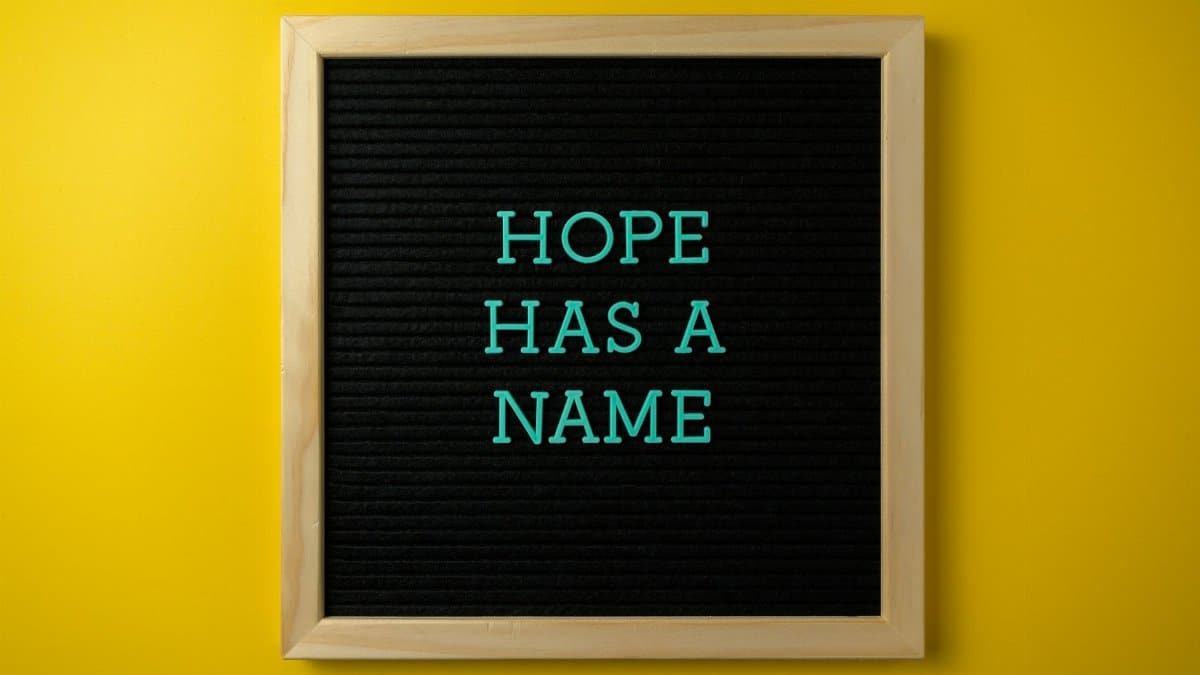 Black framed canvas with the inspirational phrase 'Hope Has a Name' on a vibrant yellow background.