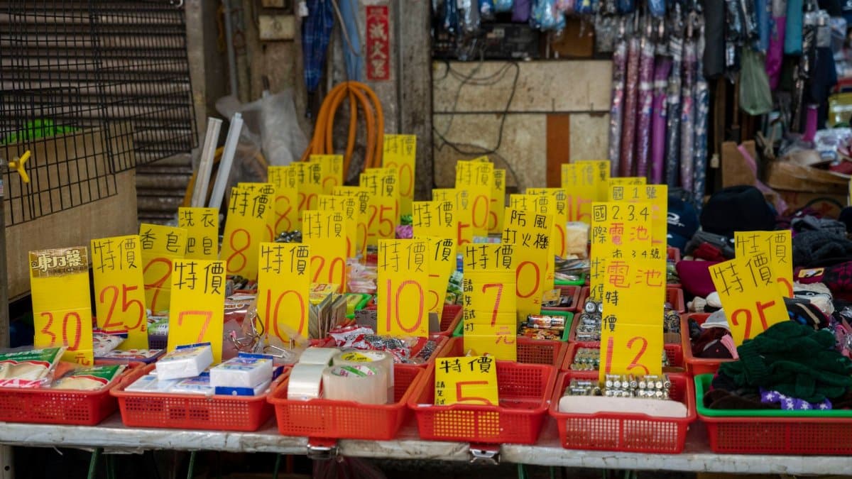 Explore a lively market stall displaying a range of goods with bold sales tags.
