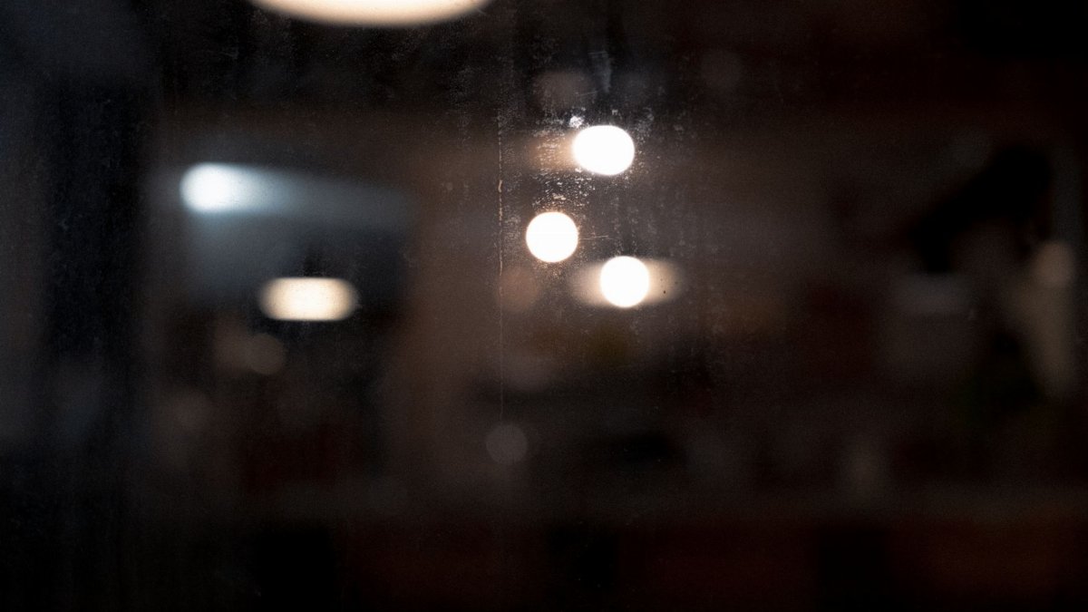 A dark abstract image showcasing blurred bokeh lights with a moody atmosphere.