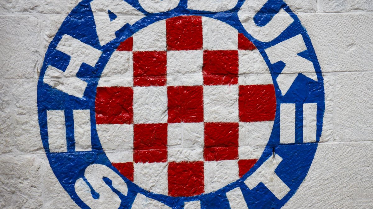 Close-up of the Hajduk Split football club emblem painted on a stone wall in Croatia.