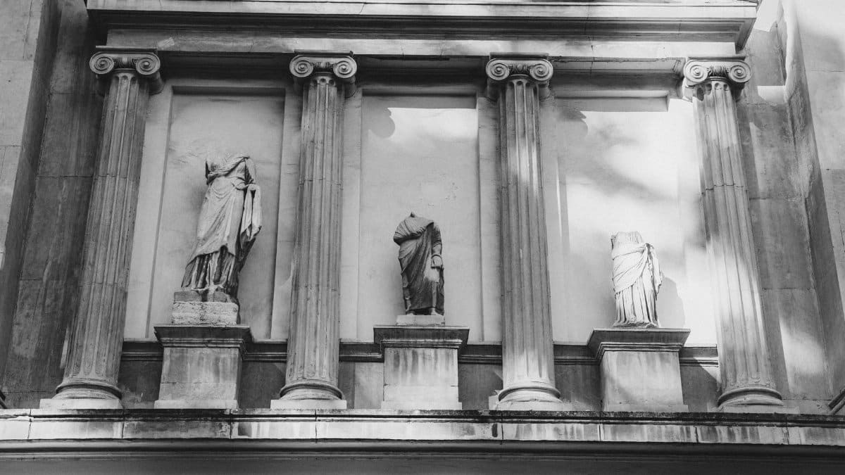 Black and white photo of a classic architectural facade with columns and statues.