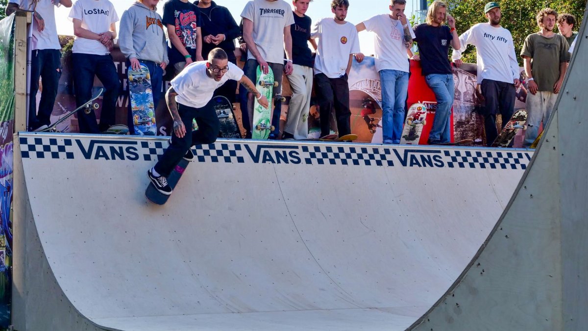 Group of skateboarders gathered at a skate park ramp in Liverpool, capturing dynamic skate action.