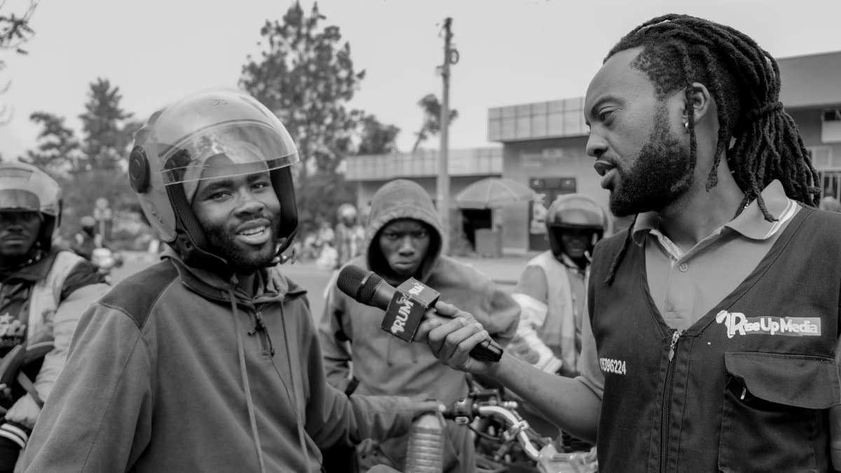 Black and white street interview with motorcycle riders captured in an urban setting.