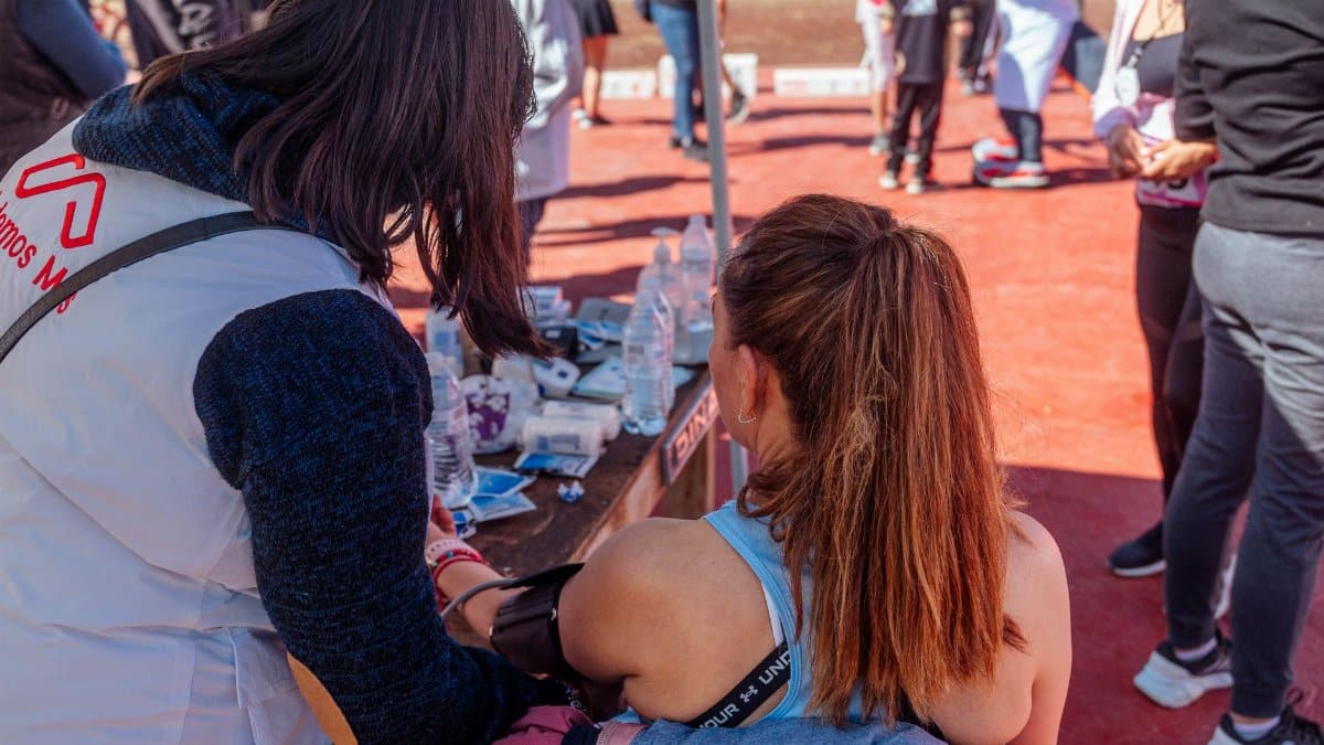 First aid being administered at an outdoor sports event with attendees.