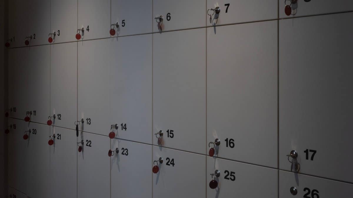 A row of wall-mounted lockers with keys in an indoor setting, ideal for storage solutions.