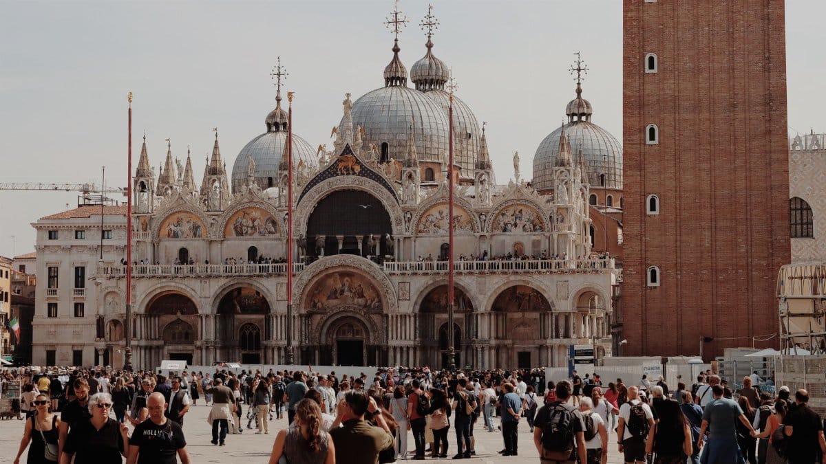 Capture of a bustling crowd at Piazza San Marco, Venice, highlighting its historic architecture.