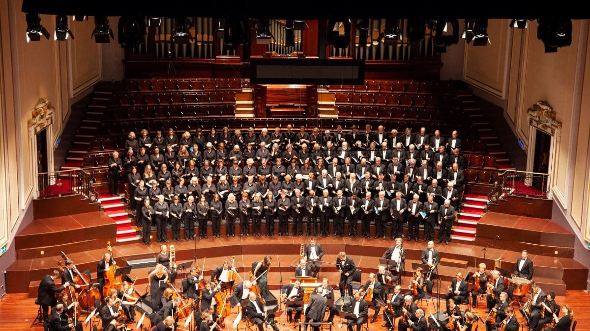 A majestic orchestra and choir performing at a historic venue in Edinburgh, Scotland.