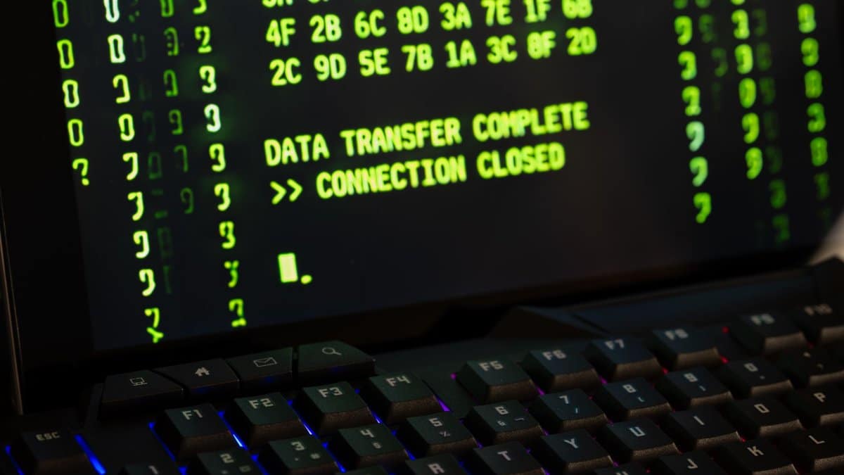 Data transfer complete message displayed on a computer monitor with a keyboard underneath.