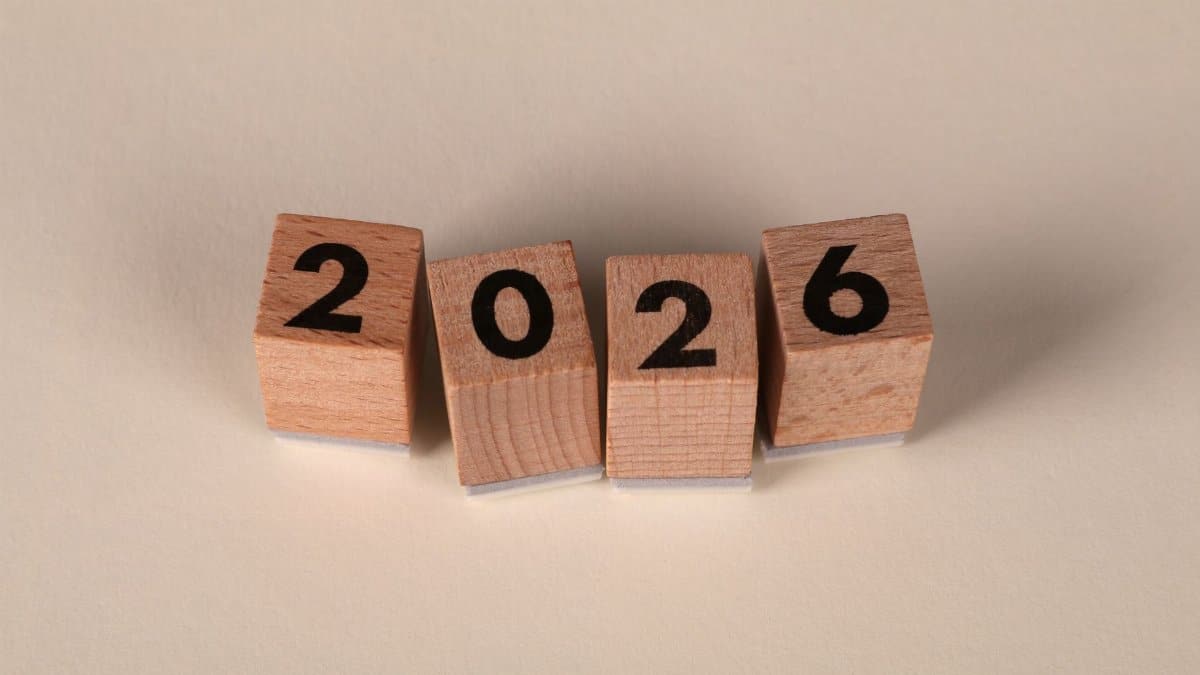 Wooden cubes forming the year 2026 on a neutral background.