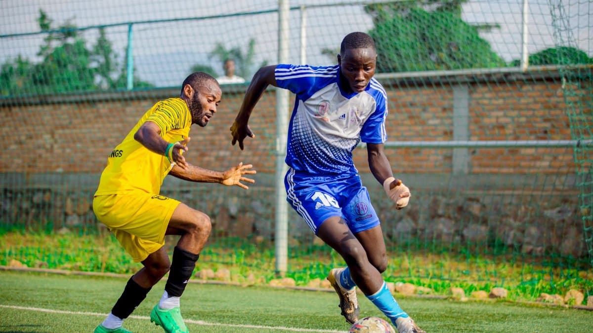 Two male soccer players engage in an intense match on an outdoor field.