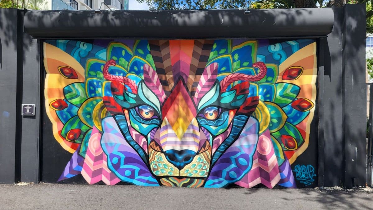 Vibrant mural of a lion with geometric patterns and bright colors in Miami's Wynwood Walls.