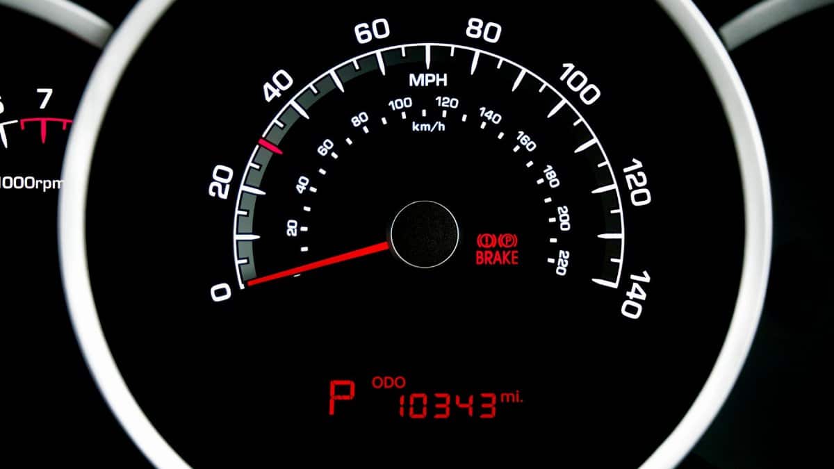 Close-up view of a car speedometer showing speed in MPH and odometer reading 10343 miles.