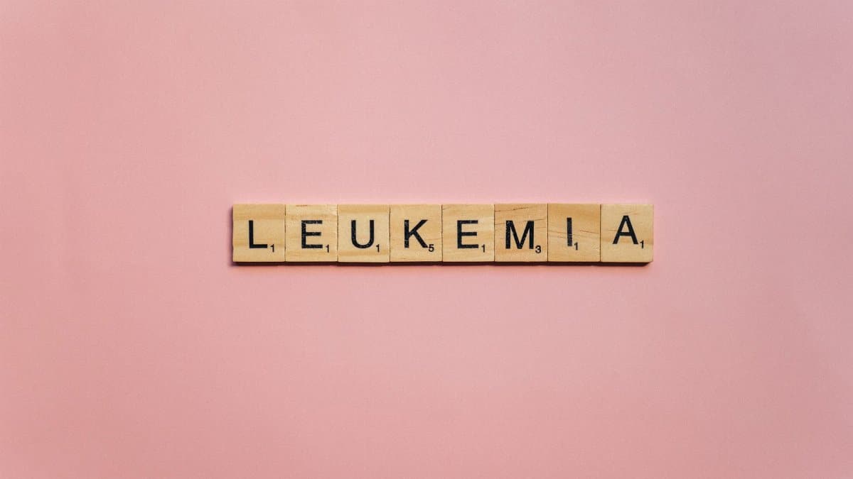Wooden tiles spelling out 'Leukemia' on a pink background, symbolizing health awareness.