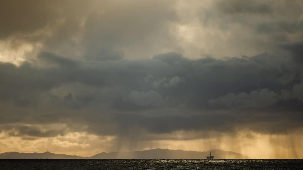 Moody storm clouds gathering over the ocean at Newport Beach, California, creating a dramatic seascape.