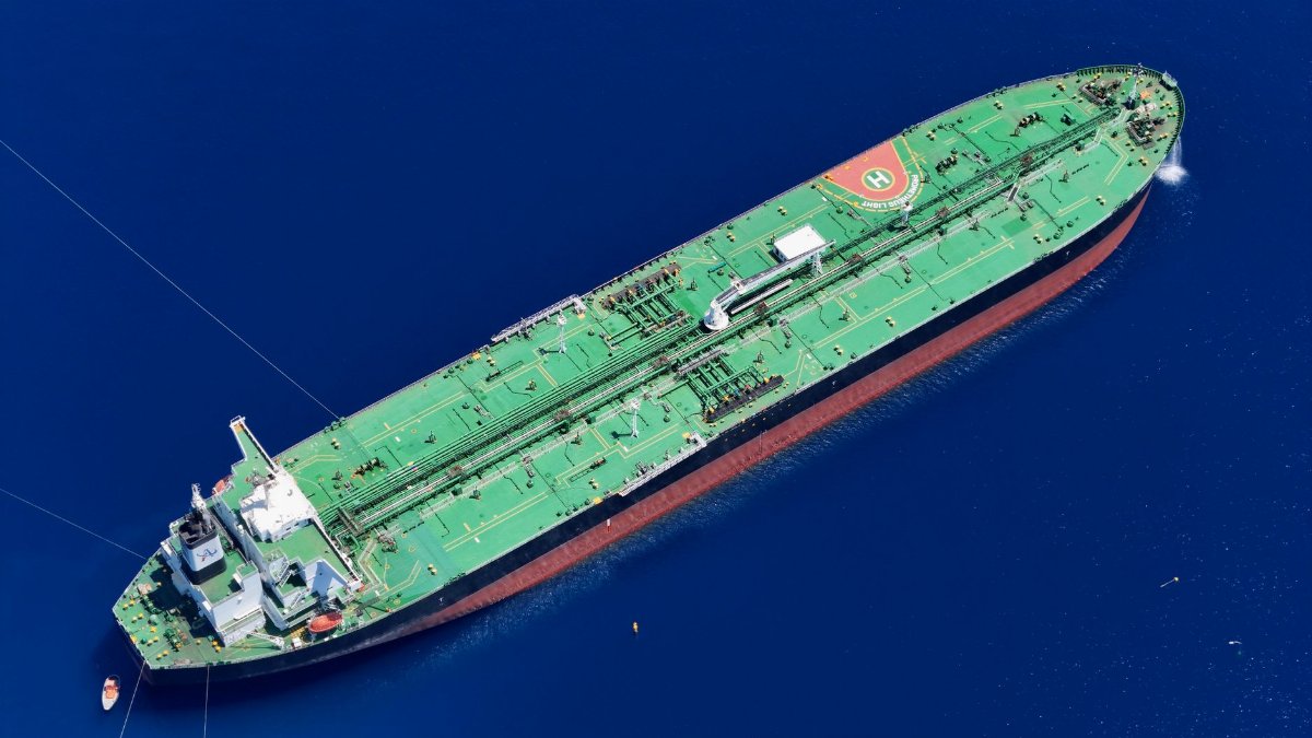 Aerial shot of an oil tanker sailing in the ocean near Vado Ligure, Italy.